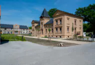 kleines Schloss mit Turm und park von der Seite fotografiert