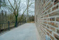 Balkon eines sanierten Gebäudes mit Ziegelfassade